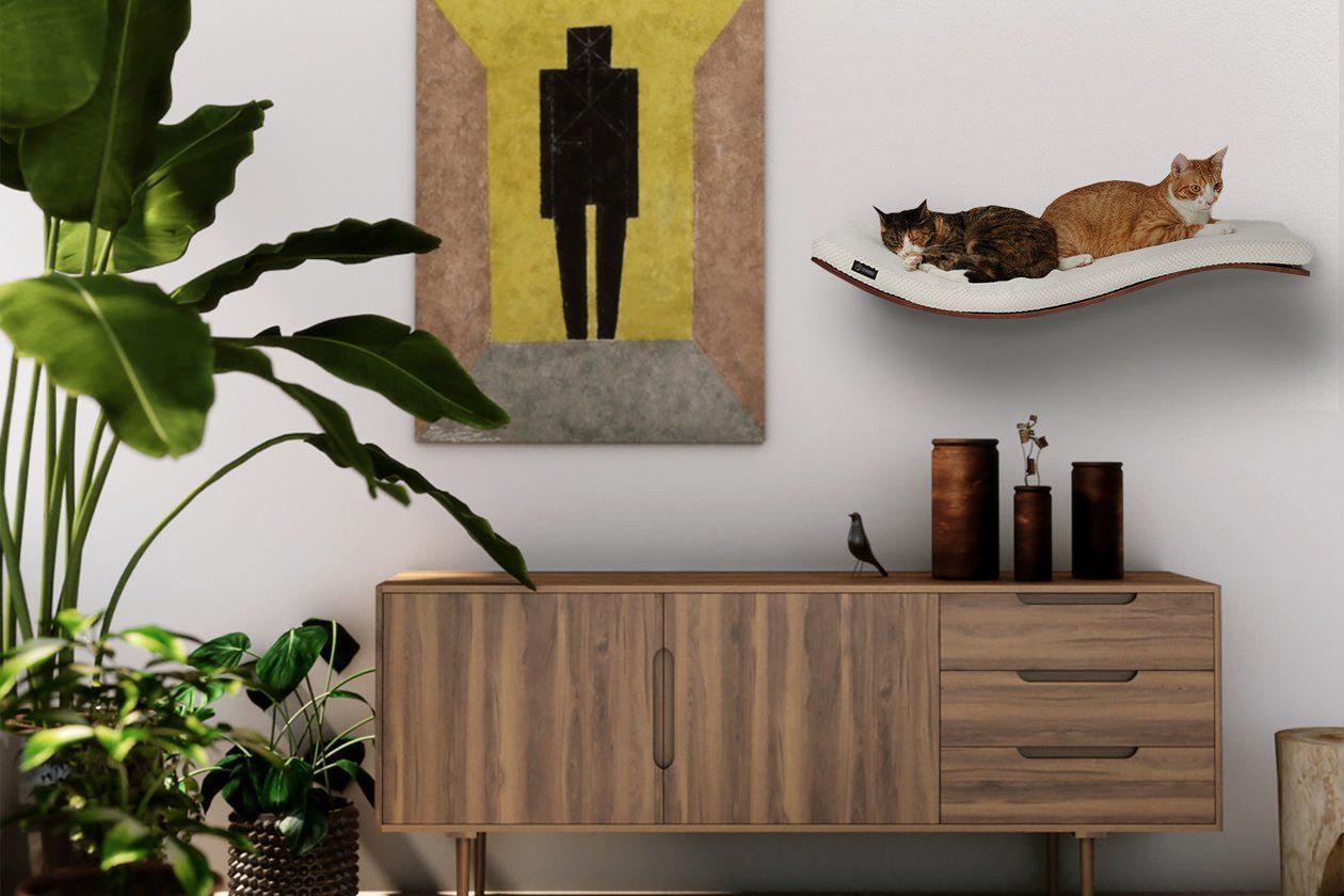 The Freddo cat shelf from Tuft + Paw is a great piece to accompany your floating gently curved cat perch, they are both great modern cat wall shelves.