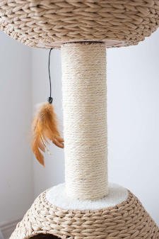 The central scratching post that supports the top bed on this wicker style paper rope cat tree.